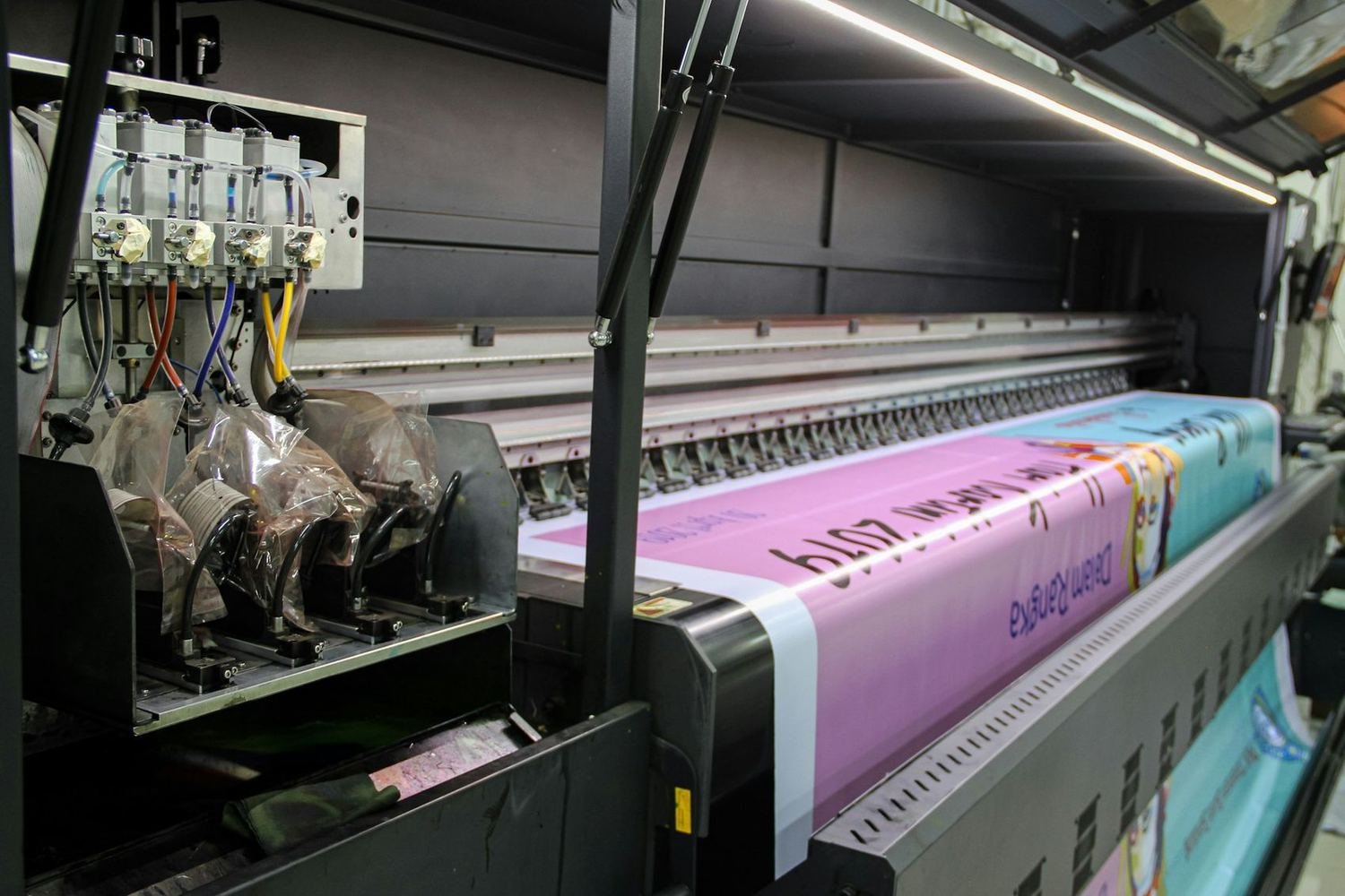 A large format printer producing a full colour banner